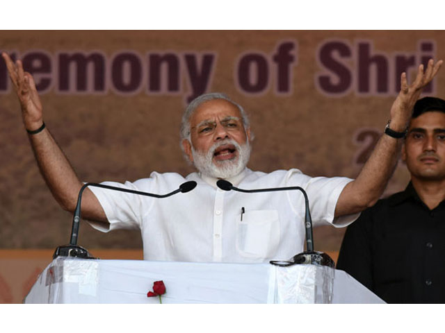 in this photograph taken on may 24 2016 indian prime minister narendra modi gestures as he addresses the audience during the swearing in ceremony of sarbananda sonowal as the chief minister of the north eastern state of assam in guwahati photo afp