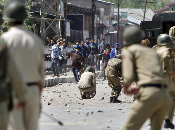 kashmiri protesters throw stones towards indian policemen during a daylong protest strike in narbal north of srinagar april 18 2015 photo reuters
