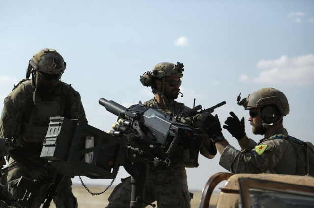 this file photo taken on may 25 2016 shows men in uniform identified by syrian democratic forces as us special operations forces as they ride in the back of a pickup truck in the village of fatisah in the northern syrian province of raqa us special operations forces photographed in syria wearing the insignia of kurdish troops considered terrorists by turkey have been ordered to remove the patches a military spokesman said may 27 2016 ankara accused the united states a nato ally of quot unacceptable quot behavior for such an overt display of support for the kurdish people 039 s protection units ypg afp photo