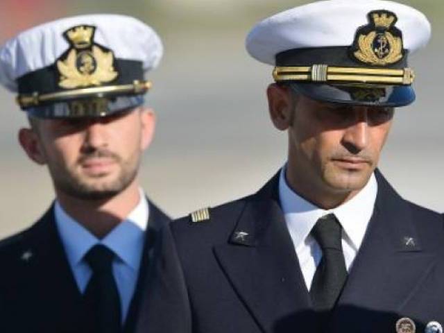 italian marines massimiliano lattore right and salvatore girone left arrive at ciampino airport near rome on december 22 2012 photo afp