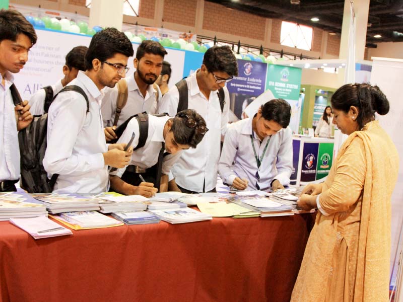 students gather around one of the stalls at the career and education expo photo aysha saleem express