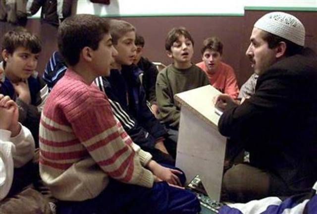 young boys read suras during the study of the quran at the central mosque in berlin 039 s kreuzberg district october 30 2001 photo reuters young boys read suras during the study of the quran at the central mosque in berlin 039 s kreuzberg district october 30 2001 photo reuters