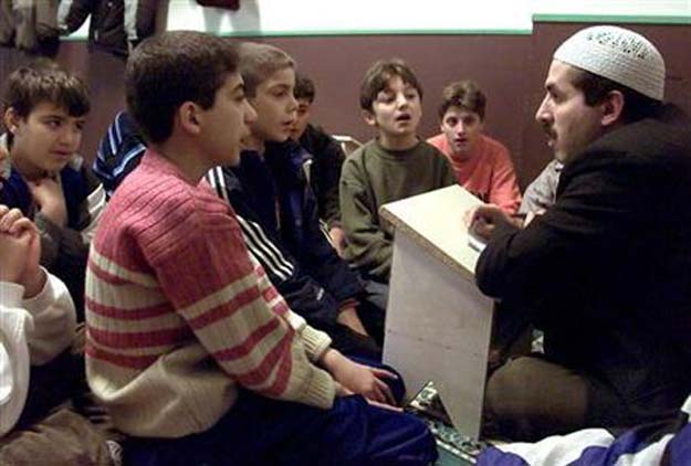 young boys read suras during the study of the quran at the central mosque in berlin 039 s kreuzberg district october 30 2001 photo reuters