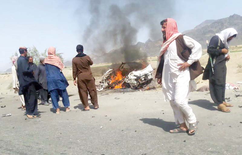 people gather around a destroyed vehicle in which mullah akhtar mansour was travelling on may 21 2016 photo afp