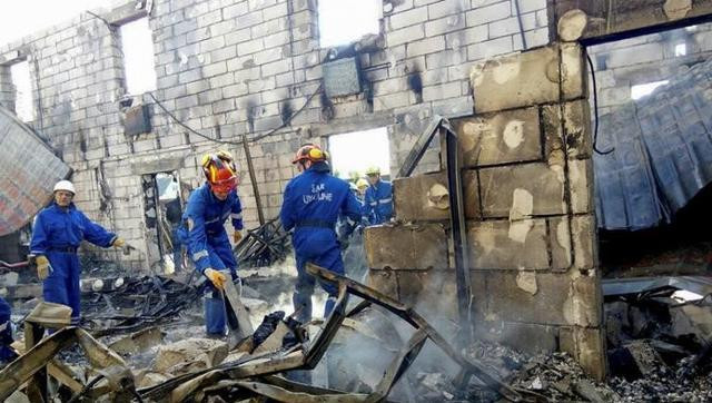 rescuers inspect the debris of a residential house after a fire broke out in the village of litochky northeast of kiev ukraine may 29 2016 photo reuters
