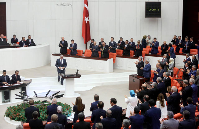 turkey 039 s new prime minister binali yildirim c is applauded as he arrives at the general session at grand national assembly of turkey tbmm in ankara turkey on may 29 2016