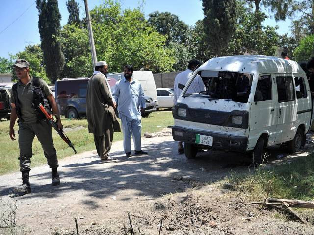 police officials inspect the site of a roadside bomb explosion in peshawar on may 18 2016 photo afp police officials inspect the site of a roadside bomb explosion in peshawar on may 18 2016 photo afp