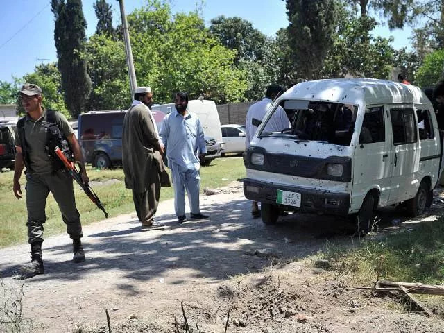 police officials inspect the site of a roadside bomb explosion in peshawar on may 18 2016 photo afp police officials inspect the site of a roadside bomb explosion in peshawar on may 18 2016 photo afp