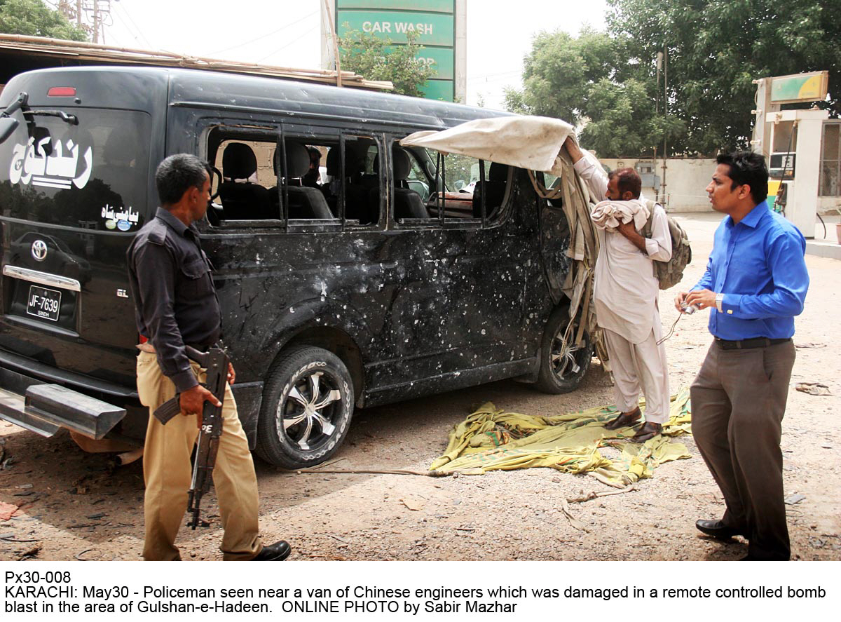 policemen inspect the car damaged in the incident on monday photo