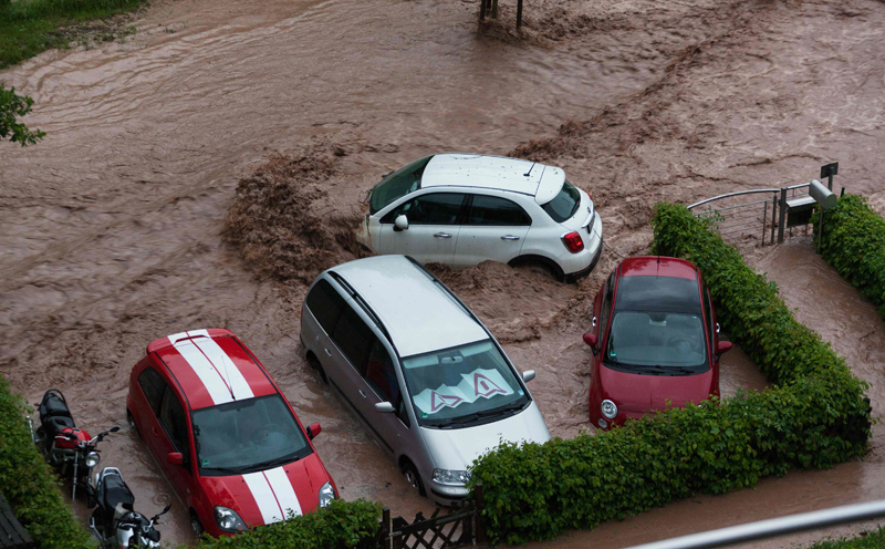 cars are seen in a flooded street in southern germany after heavy rains hit the country on may 29 2016 three people died and several were injured after heavy rains in the country officials said on may 30 2016 afp photo