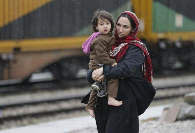 a migrant woman from afghanistan stands with her child at the macedonian serbian border near the village of tabanovce macedonia february 24 2016 photo reuters a migrant woman from afghanistan stands with her child at the macedonian serbian border near the village of tabanovce macedonia february 24 2016 photo reuters