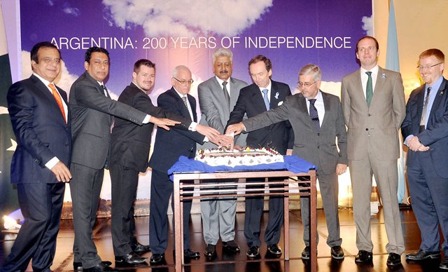 federal minister for states and frontier regions minister abdul qadir baloch c argentinean ambassador ivan ivanissevich 3r cutting a cake to mark the 200th independence day of argentina photo nni