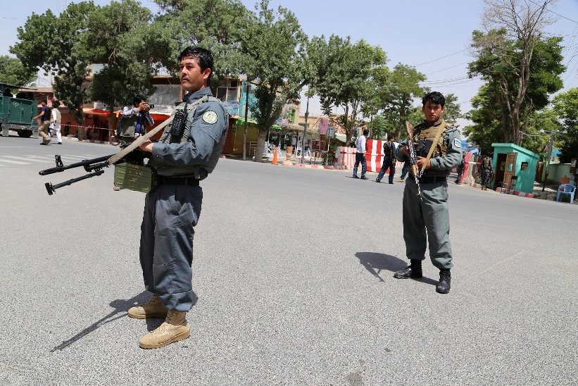 afghan security force personnel stand alert at the entrance to a provincial court in ghazni on june 1 2016 after a group of taliban gunmen targeted the building photo reuters