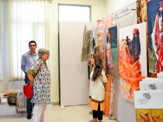 a student discusses her work with salima hashmi at the exhibition photo our correspondent a student discusses her work with salima hashmi at the exhibition photo our correspondent