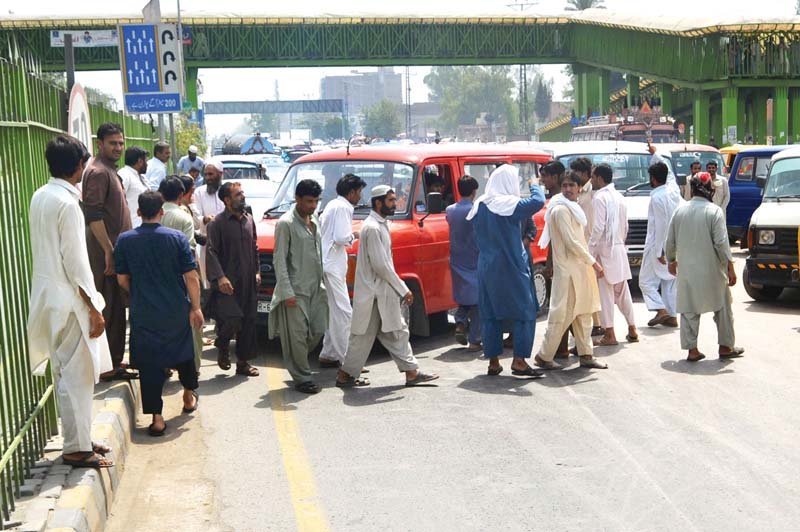 transporters block a road in the city to protest increase in fines photo express