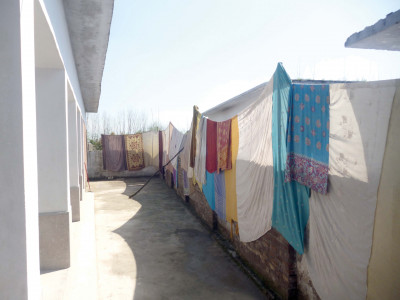 students teachers build school boundary wall with shawls in mardan