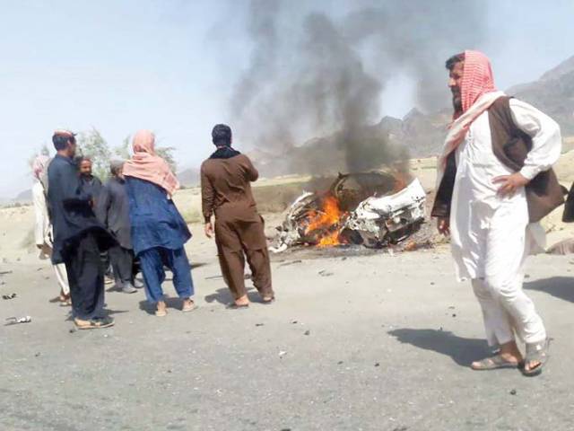 people gather around a destroyed vehicle in which mullah akhtar mansour was travelling on may 21 2016 photo afp