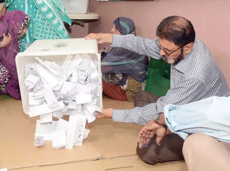 a election official empties a ballot box to start counting of votes in pib colony of karachi photo mohammad noman express a election official empties a ballot box to start counting of votes in pib colony of karachi photo mohammad noman express