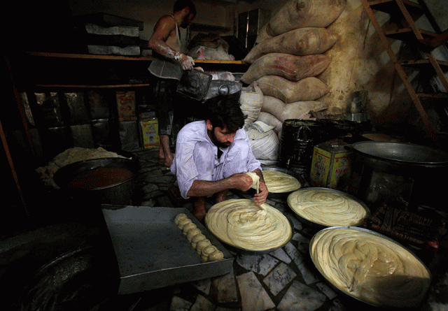 a baker prepares dough for bread ahead of ramazan in peshawar photo reuters