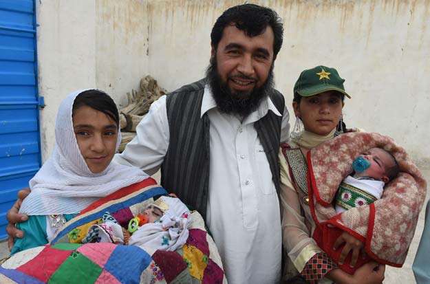 in this photograph taken on march 23 2016 pakistani father sardar haji jan mohammad khilji poses with some of his children at his residence in quetta photo afp