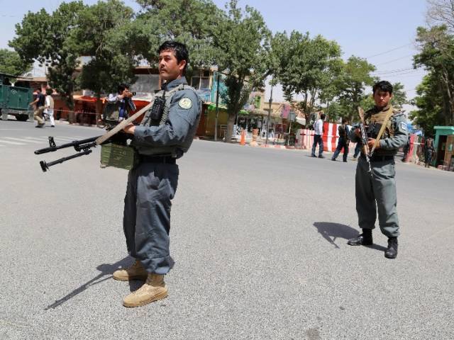 afghan security force personnel stand alert at the entrance to a provincial court in ghazni on june 1 2016 after a group of taliban gunmen targeted the building photo reuters