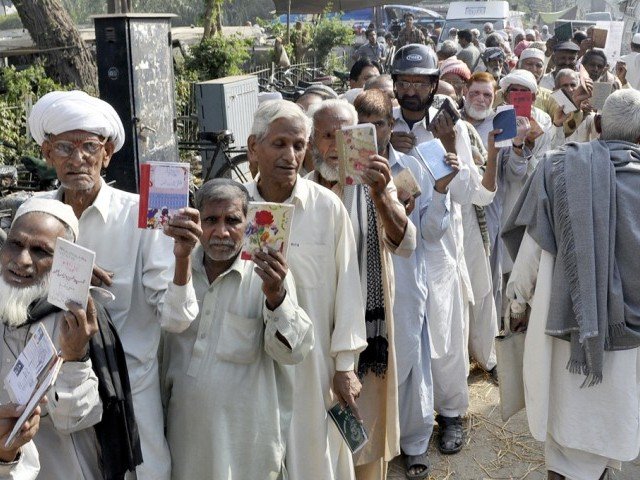 pensioners waiting outside the bank to receive their payments photo express file