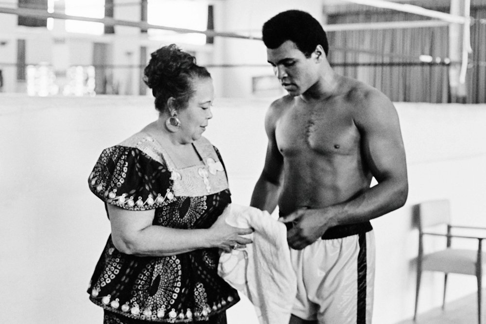 this file photo taken on october 27 1974 shows us boxing heavyweight champion muhammad ali born cassius clay standing with her mother odessa grady clay during a training session three days before the heavy weight world championship in kinshasa boxing icon muhammad ali died on friday june 3 a family spokesman said in a statement quot after a 32 year battle with parkinson s disease muhammad ali has passed away at the age of 74 quot spokesman bob gunnell said photo afp