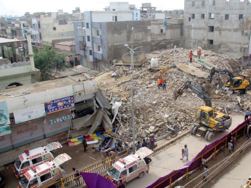 workers remove rubble of the building which collapsed in the surjani town area photo online