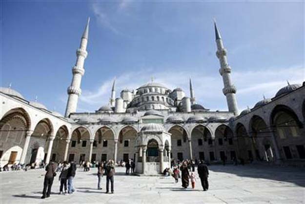 people walk in the compounds of the blue mosque in istanbul april 5 2009 photo reuters