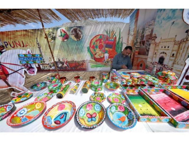 a local painter decorates utensils with truck arts in orakzai festival photo express