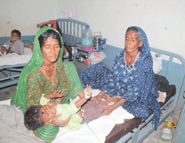 women from tharparkar attend a sick child in civil hospital hyderabad photo file women from tharparkar attend a sick child in civil hospital hyderabad photo file