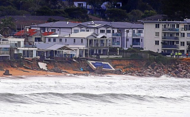 officials stand near a swimming pool and houses that suffered damage after severe weather that brought strong winds and heavy rain to the east coast of australia at collaroy beach in sydney australia june 6 2016 photo reuters officials stand near a swimming pool and houses that suffered damage after severe weather that brought strong winds and heavy rain to the east coast of australia at collaroy beach in sydney australia june 6 2016 photo reuters