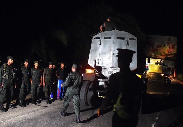 in this photo taken late on june 5 2016 sri lankan soldiers gather at a distance as smoke and fire rise following explosions at an army ammunition dump at salawa military camp on the outskirts of colombo powerful explosions continued to ripple through a military ammunition depot on the edge of sri lanka 039 s capital june 6 as firefighters battled huge blazes six hours after the initial blasts that have forced thousands to flee afp photo in this photo taken late on june 5 2016 sri lankan soldiers gather at a distance as smoke and fire rise following explosions at an army ammunition dump at salawa military camp on the outskirts of colombo powerful explosions continued to ripple through a military ammunition depot on the edge of sri lanka 039 s capital june 6 as firefighters battled huge blazes six hours after the initial blasts that have forced thousands to flee afp photo