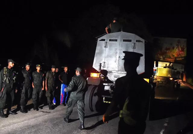in this photo taken late on june 5 2016 sri lankan soldiers gather at a distance as smoke and fire rise following explosions at an army ammunition dump at salawa military camp on the outskirts of colombo powerful explosions continued to ripple through a military ammunition depot on the edge of sri lanka 039 s capital june 6 as firefighters battled huge blazes six hours after the initial blasts that have forced thousands to flee afp photo in this photo taken late on june 5 2016 sri lankan soldiers gather at a distance as smoke and fire rise following explosions at an army ammunition dump at salawa military camp on the outskirts of colombo powerful explosions continued to ripple through a military ammunition depot on the edge of sri lanka 039 s capital june 6 as firefighters battled huge blazes six hours after the initial blasts that have forced thousands to flee afp photo