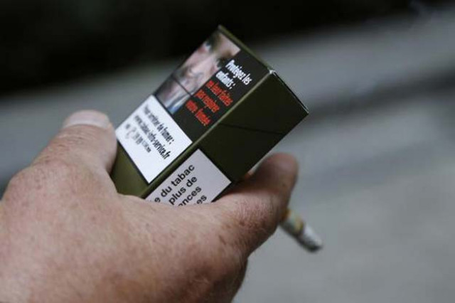 a man smokes a cigarette on september 25 2014 in paris holding a sample of a plain cigarette packaging cigarette box photo afp a man smokes a cigarette on september 25 2014 in paris holding a sample of a plain cigarette packaging cigarette box photo afp