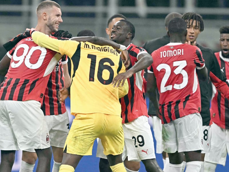 milan s players celebrate after winning the italian serie a football match between inter and ac milan at san siro stadium in milan on september 22 2024 photo afp