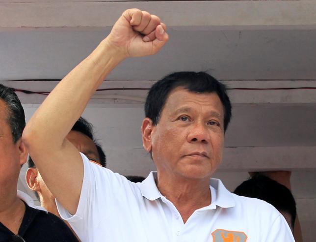 rodrigo duterte philippine presidential candidate and a local mayor raises his fist during a motorcade photo reuters