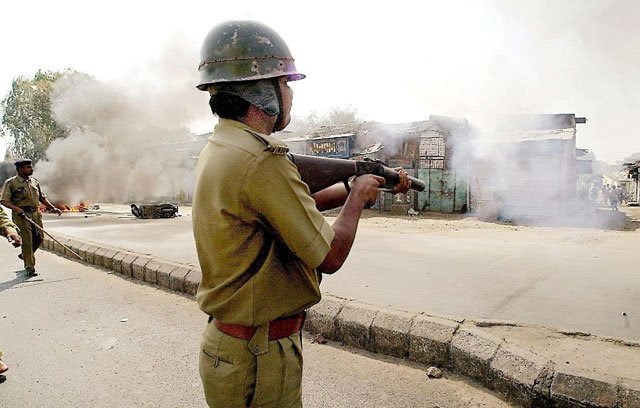 riot police fire tear gas to disperse a hindu mob that attacked a mosque in ahmedabad in gujarat on february 28 2002 photo afp