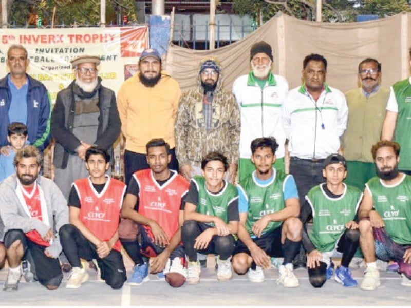 international basketball player zafar iqbal chaudhry is seen with the players of the finalist teams aram bagh club and civil tiger club on sunday photo app