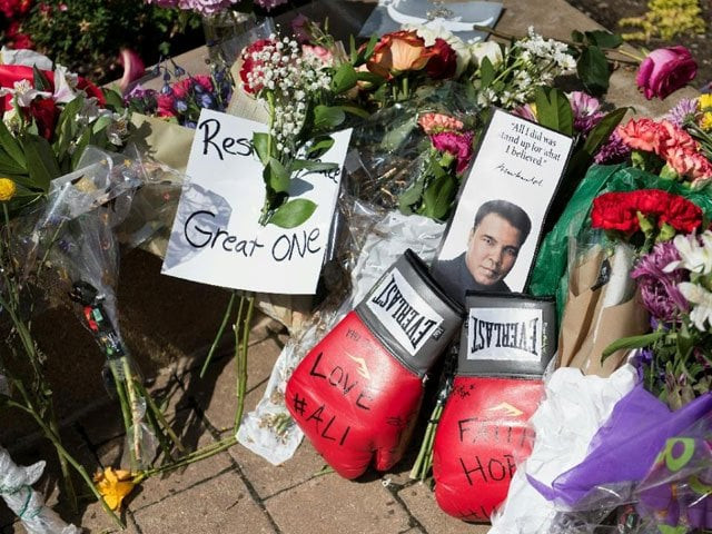 flowers and boxing gloves are left at a memorial to boxing legend muhammad ali at the muhammad ali center june 5 2016 in louisville kentucky photo afp flowers and boxing gloves are left at a memorial to boxing legend muhammad ali at the muhammad ali center june 5 2016 in louisville kentucky photo afp