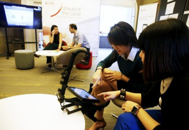 ubs employees march 17 2016 show how their eye movements are tracked to provide feedback on the interface design of a banking application on a tablet computer at their innovation centre evolve in singapore photo reuters ubs employees march 17 2016 show how their eye movements are tracked to provide feedback on the interface design of a banking application on a tablet computer at their innovation centre evolve in singapore photo reuters