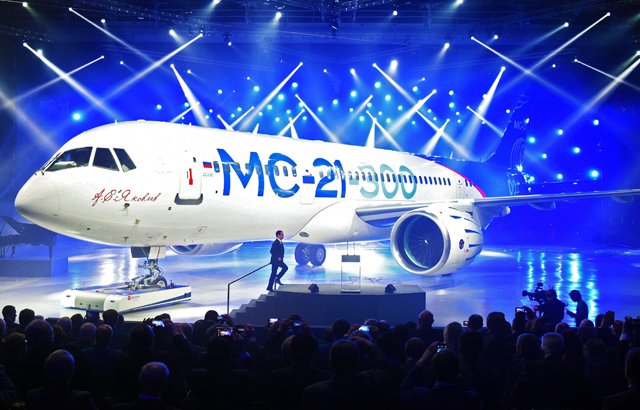 russian prime minister dmitry medvedev arrives to give a speech in front of the new medium haul mc 21 airliner during the roll out ceremony at an aircraft plant in irkutsk on june 8 2016 afp photo