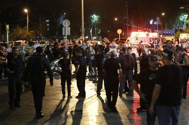 israeli security forces emergency personnel and civilians are seen at the site of a gun attack in the coastal city of tel aviv on june 8 2016