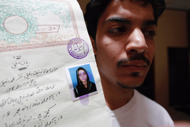 hassan khan shows a document with a photograph of his wife zeenat bibi who was burnt alive by her mother at his residence in lahore on june 8 2016 photo afp hassan khan shows a document with a photograph of his wife zeenat bibi who was burnt alive by her mother at his residence in lahore on june 8 2016 photo afp