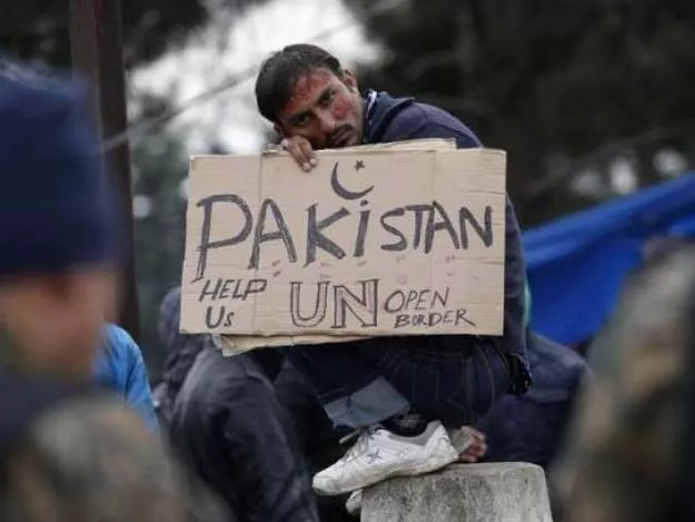 a migrant from pakistan holds a placard while waiting to cross the border from greece into macedonia near gevgelija macedonia november 26 2015 photo reuters a migrant from pakistan holds a placard while waiting to cross the border from greece into macedonia near gevgelija macedonia november 26 2015 photo reuters