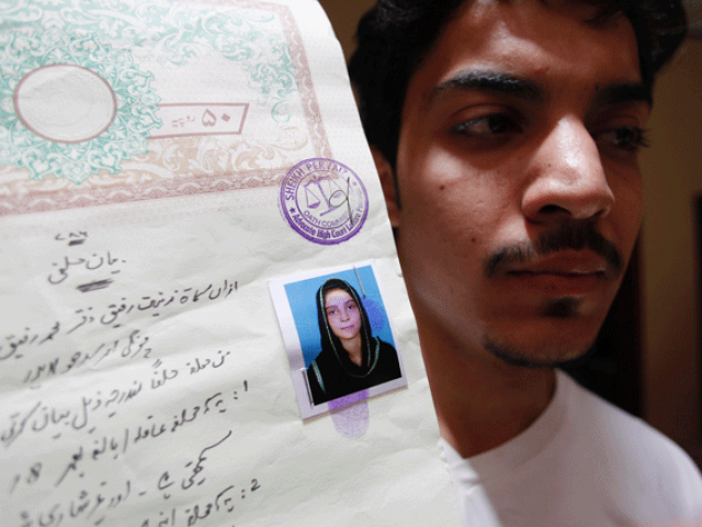 hassan khan shows a document with a photograph of his wife zeenat bibi who was burnt alive by her mother at his residence in lahore on june 8 2016 photo afp hassan khan shows a document with a photograph of his wife zeenat bibi who was burnt alive by her mother at his residence in lahore on june 8 2016 photo afp