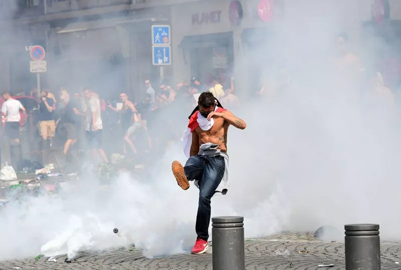 an england fan kicks away a tear gas canister after tear gas was released by french police in the city of marseille southern france on june 11 2016 ahead of the euro 2016 football match between england and russia photo afp an england fan kicks away a tear gas canister after tear gas was released by french police in the city of marseille southern france on june 11 2016 ahead of the euro 2016 football match between england and russia photo afp