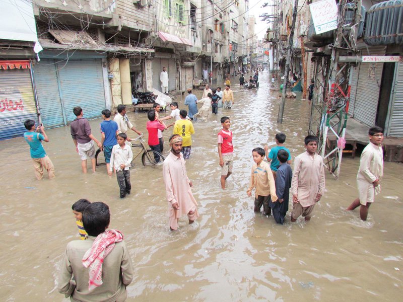 children wade in water that accumulated after it rained in sukkur which has become infamous for its terrible civic conditions photo file