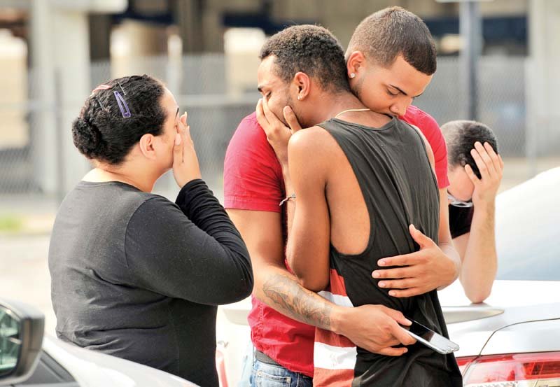 friends and family members of a victim embrace outside the orlando police hq during investigation of the shooting at the pulse night club photo reuters
