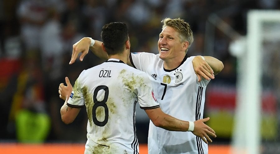 germany 039 s midfielder bastian schweinsteiger c celebrates with germany 039 s midfielder mesut oezil l after scoring a goal during the euro 2016 group c football match between germany and ukraine at the stade pierre mauroy in villeneuve d 039 ascq near lille on june 12 2016 photo afp